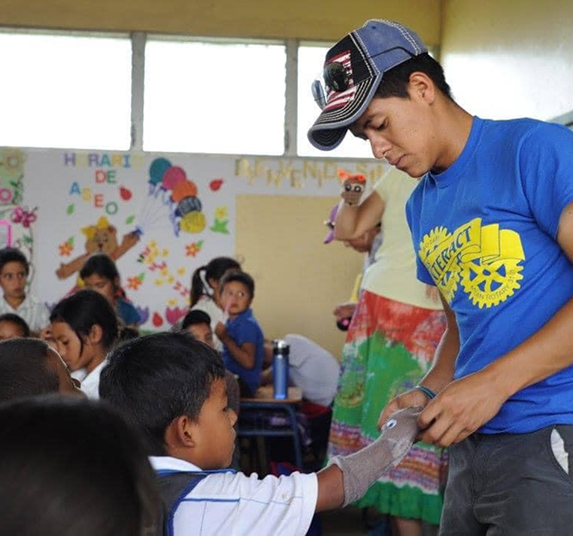 man helping boy with arm cast